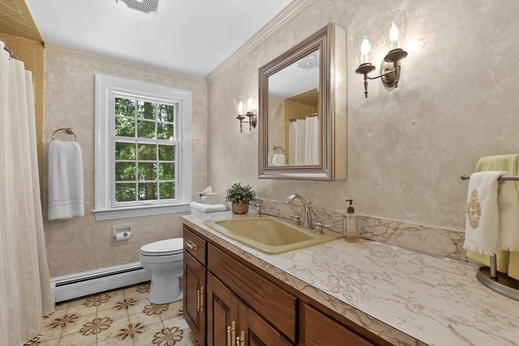 40 Herrick Road Boxford, MA 01921 - Photo 19 of 40 a bathroom with a granite countertop toilet a sink and a window