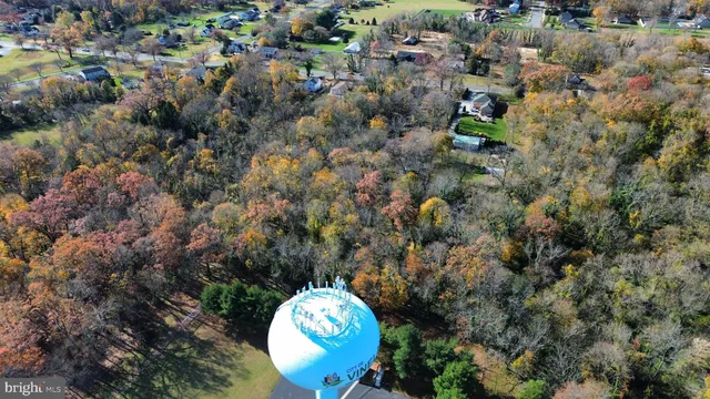 a aerial view of a house with a yard and parking space