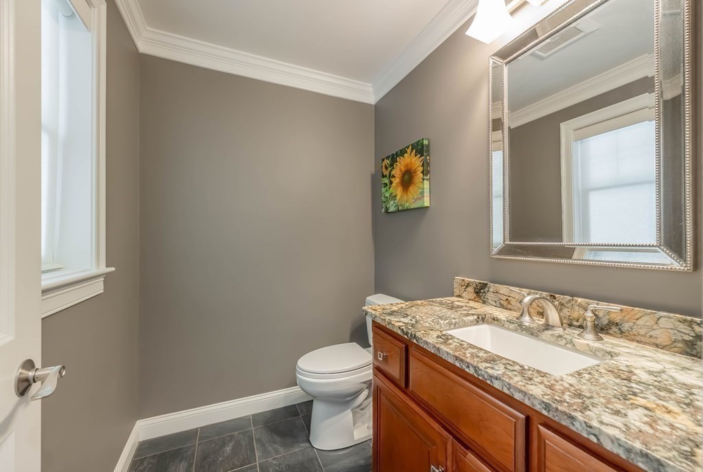 20 County Road Andover, MA 01810 - Photo 23 of 42 a bathroom with a granite countertop sink and a toilet