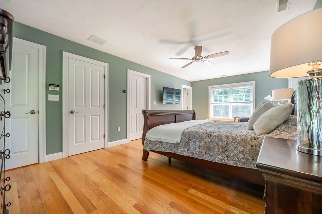 20 County Road Andover, MA 01810 - Photo 28 of 42 a bedroom with a large bed a chandelier and dresser