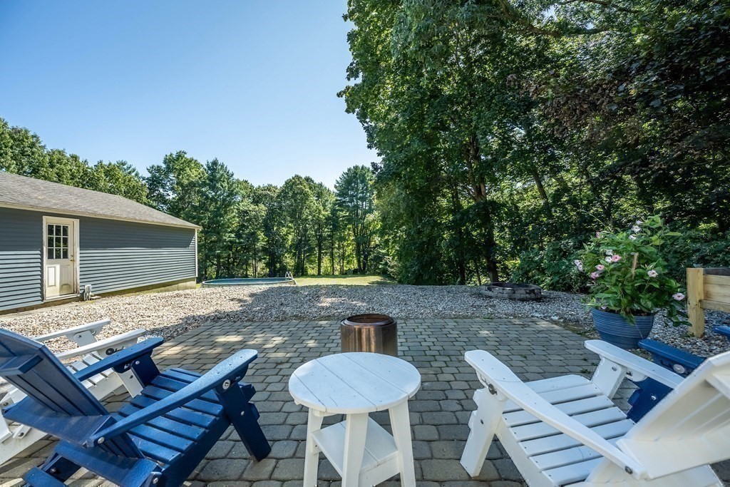 20 County Road Andover, MA 01810 - Photo 36 of 42 a view of a patio with table and chairs with wooden floor and fence