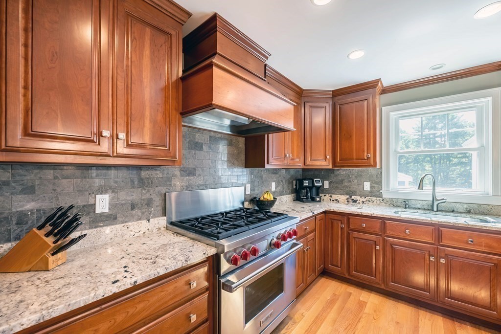 20 County Road Andover, MA 01810 - Photo 8 of 42 a kitchen with stainless steel appliances granite countertop a stove a sink dishwasher and cabinets with wooden floor