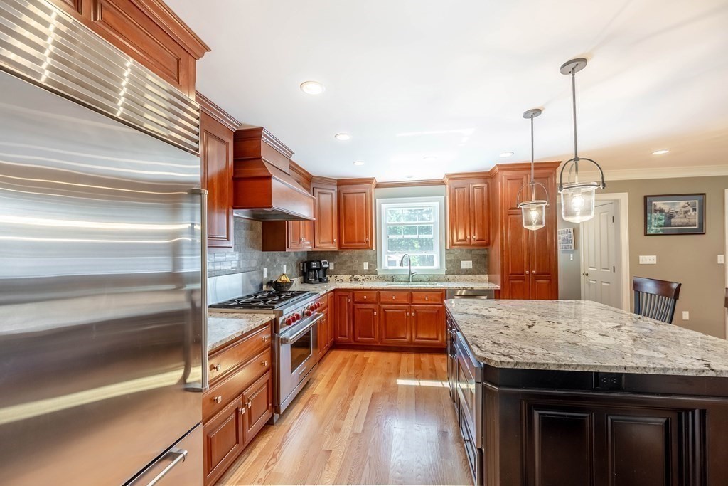 20 County Road Andover, MA 01810 - Photo 9 of 42 a kitchen with granite countertop a stove and a wooden floor