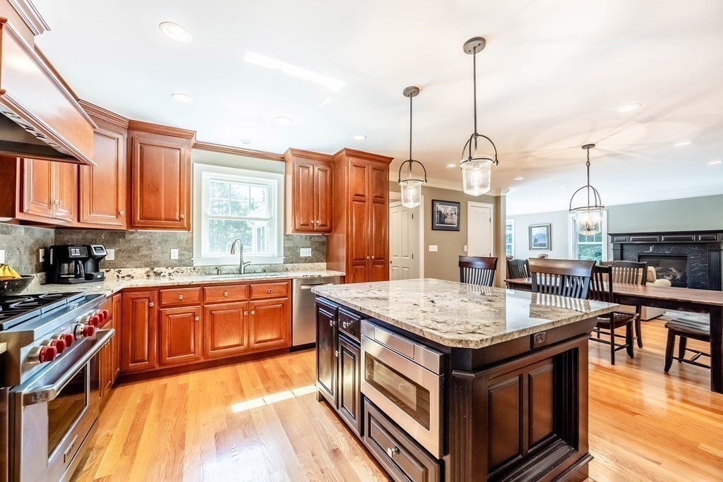 20 County Road Andover, MA 01810 - Photo 10 of 42 a kitchen with stainless steel appliances granite countertop a stove a sink dishwasher and a wooden cabinets