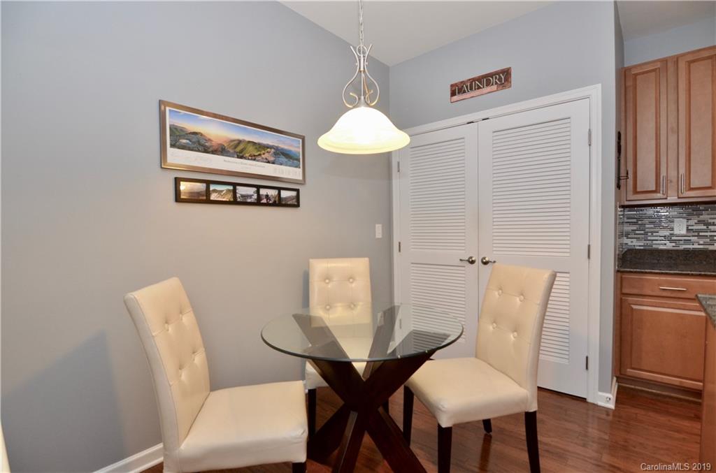 113 Inlet Point Drive Tega Cay, SC 29708 - Photo 11 of 42 a view of a dining room with furniture and wooden floor
