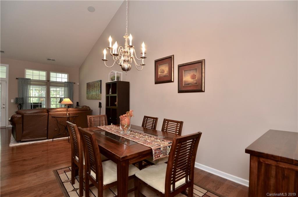 113 Inlet Point Drive Tega Cay, SC 29708 - Photo 12 of 42 a view of a dining room with furniture and wooden floor