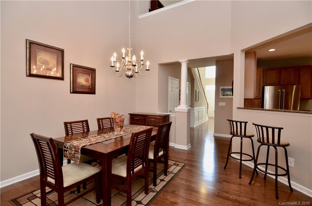 113 Inlet Point Drive Tega Cay, SC 29708 - Photo 13 of 42 a view of a dining room with furniture and wooden floor