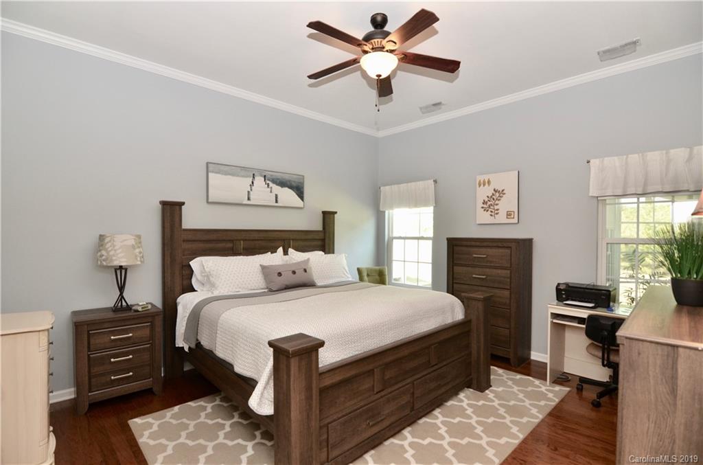 113 Inlet Point Drive Tega Cay, SC 29708 - Photo 17 of 42 a bedroom with a bed and a chandelier