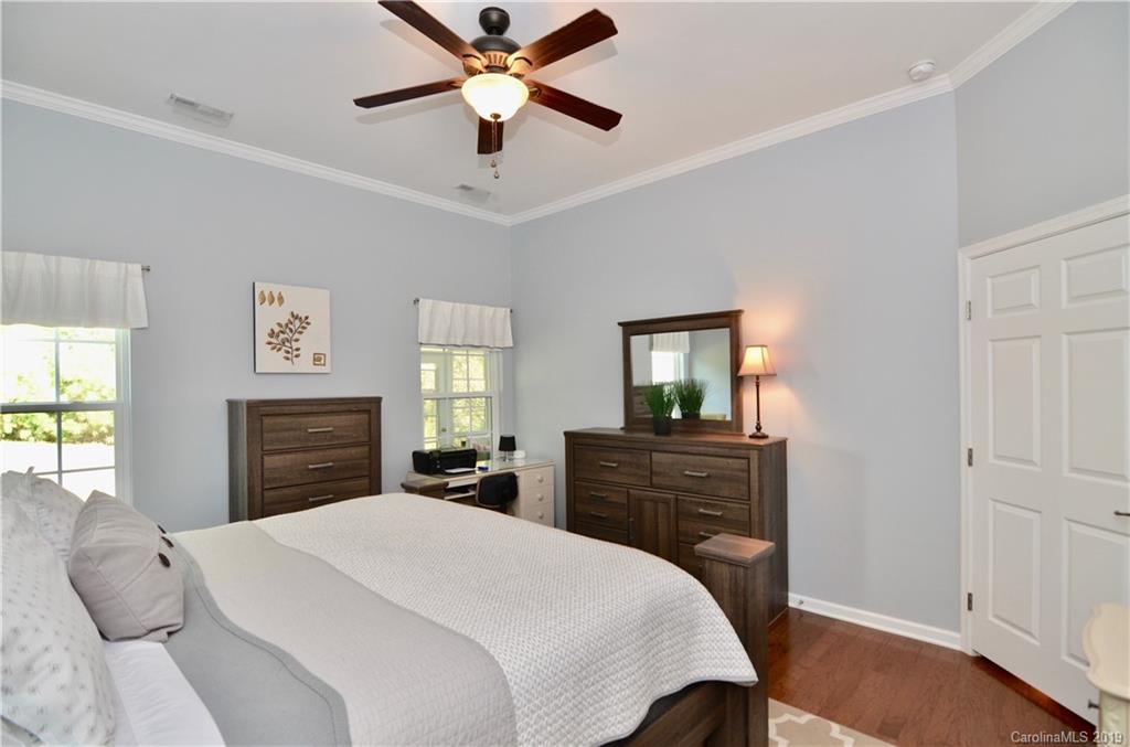 113 Inlet Point Drive Tega Cay, SC 29708 - Photo 18 of 42 a bedroom with a bed and a dresser