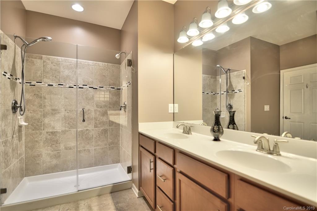 113 Inlet Point Drive Tega Cay, SC 29708 - Photo 20 of 42 a bathroom with a double vanity sink mirror and shower