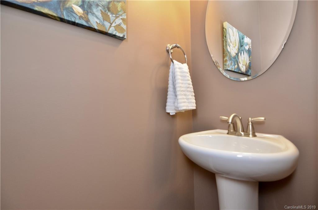 113 Inlet Point Drive Tega Cay, SC 29708 - Photo 21 of 42 a bathroom with a sink and a mirror