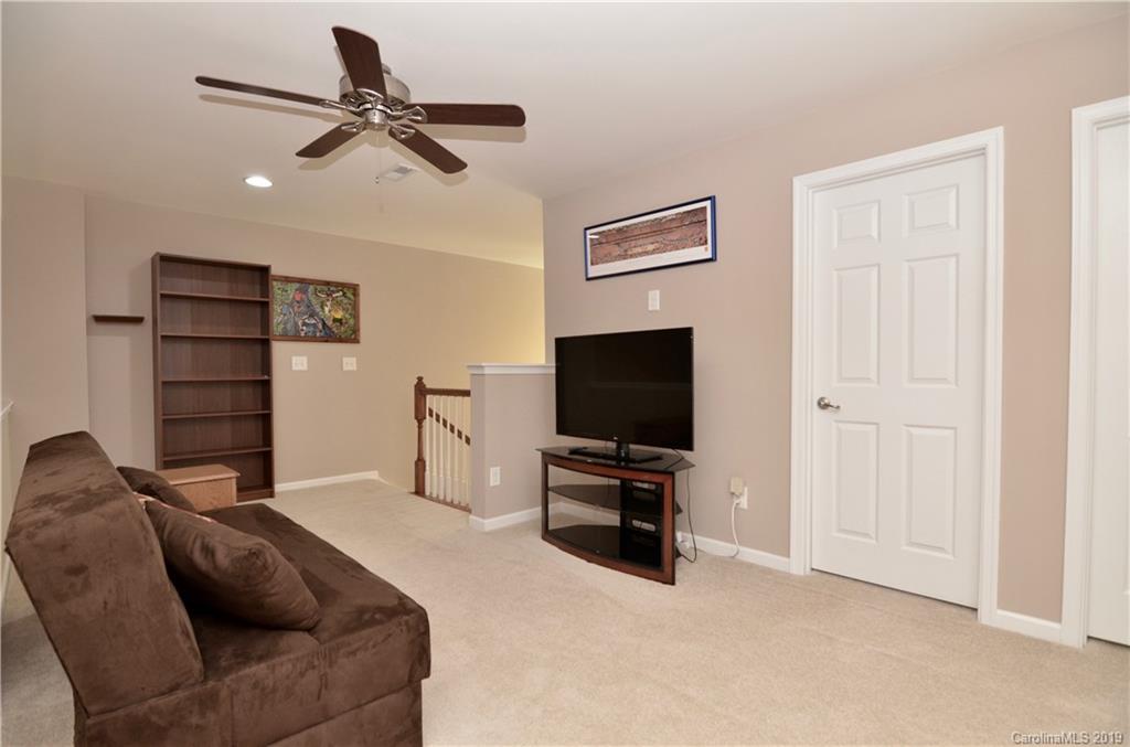 113 Inlet Point Drive Tega Cay, SC 29708 - Photo 22 of 42 a living room with furniture and a flat screen tv