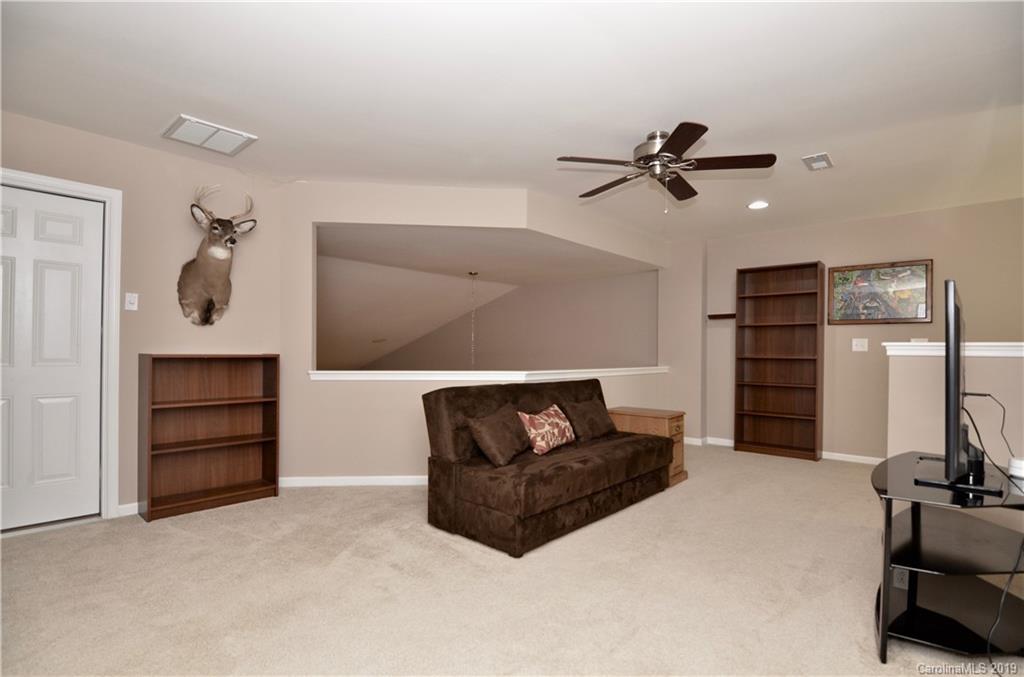 113 Inlet Point Drive Tega Cay, SC 29708 - Photo 23 of 42 a living room with furniture and a ceiling fan