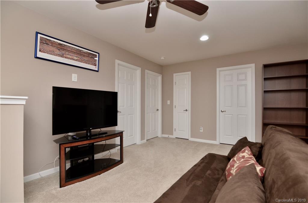 113 Inlet Point Drive Tega Cay, SC 29708 - Photo 24 of 42 a bedroom with a bed and a flat screen tv