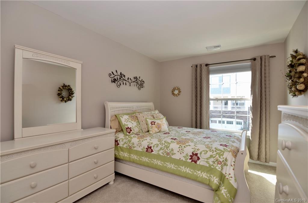 113 Inlet Point Drive Tega Cay, SC 29708 - Photo 25 of 42 a bedroom with a large bed and a window