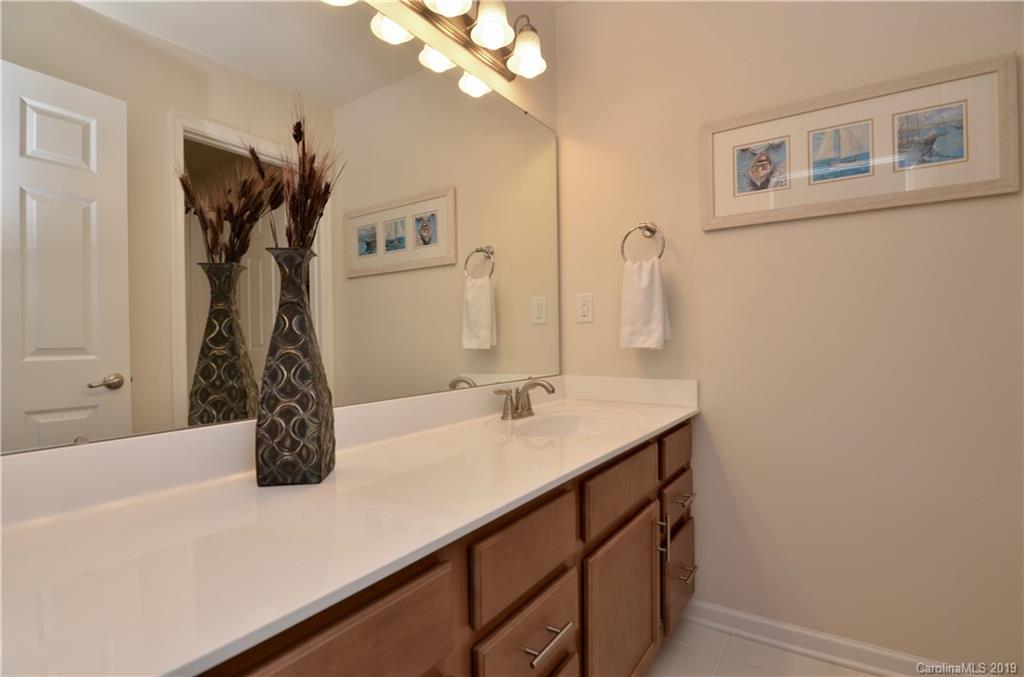 113 Inlet Point Drive Tega Cay, SC 29708 - Photo 27 of 42 a bathroom with a sink and a mirror