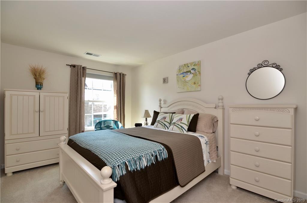 113 Inlet Point Drive Tega Cay, SC 29708 - Photo 29 of 42 a bedroom with a bed and a dresser