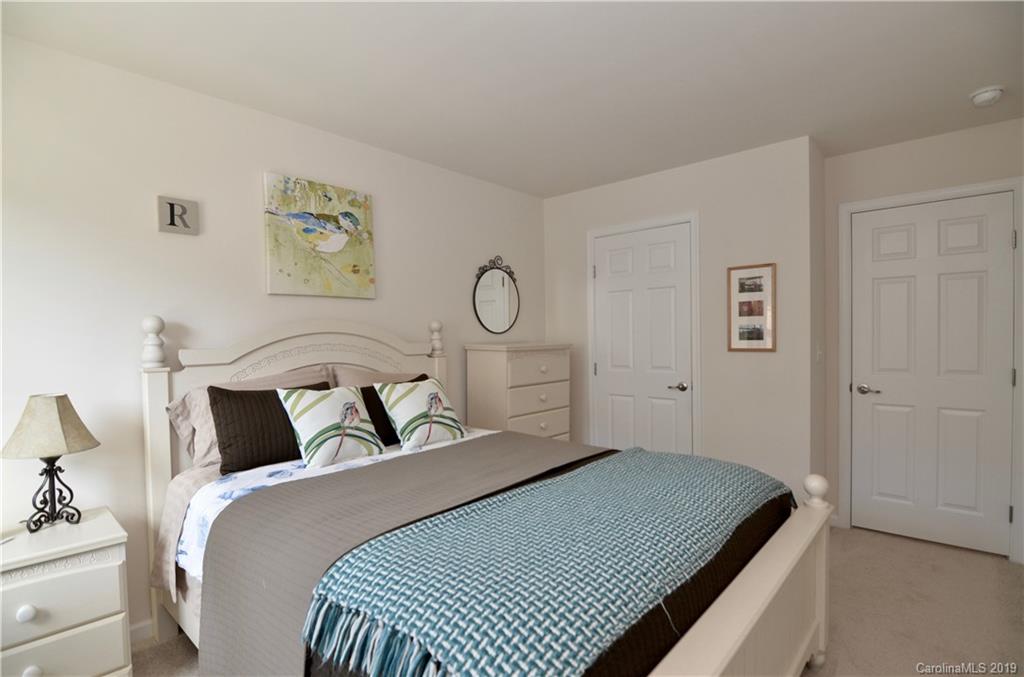 113 Inlet Point Drive Tega Cay, SC 29708 - Photo 30 of 42 a bedroom with a bed and painting on the wall