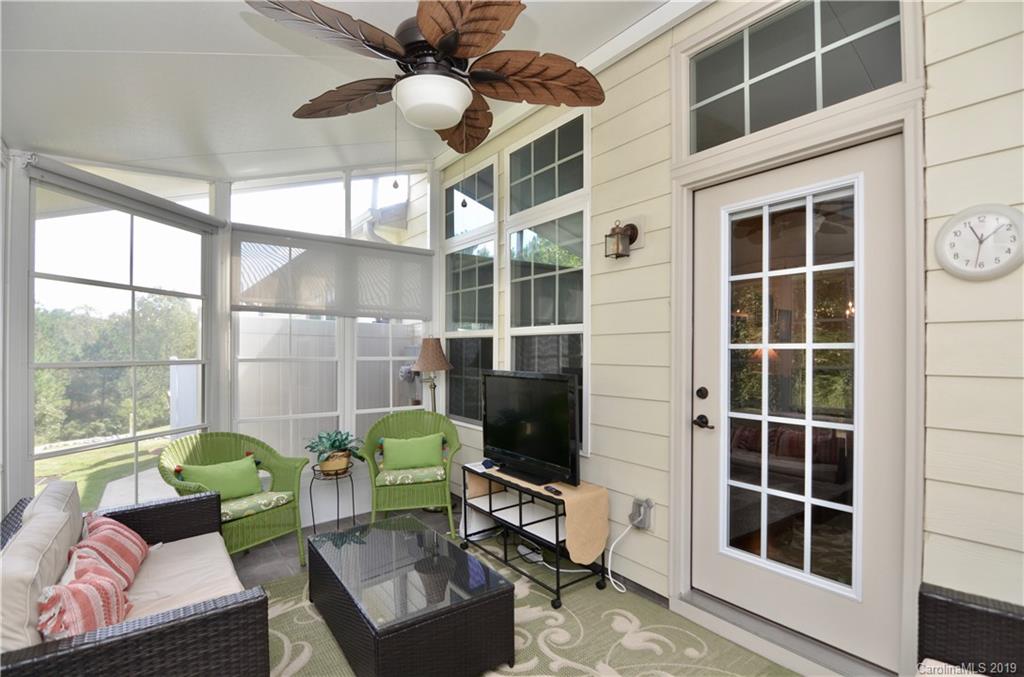 113 Inlet Point Drive Tega Cay, SC 29708 - Photo 32 of 42 a living room with furniture and a large window