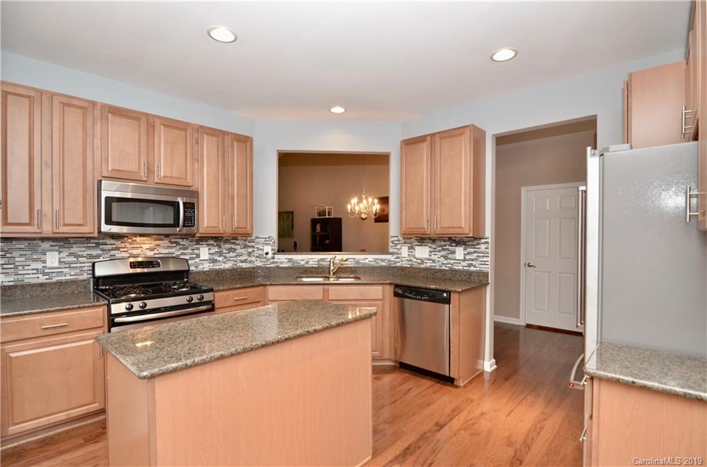 113 Inlet Point Drive Tega Cay, SC 29708 - Photo 7 of 42 a kitchen with stainless steel appliances granite countertop a stove a sink and a refrigerator