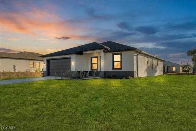 a front view of a house with a garden