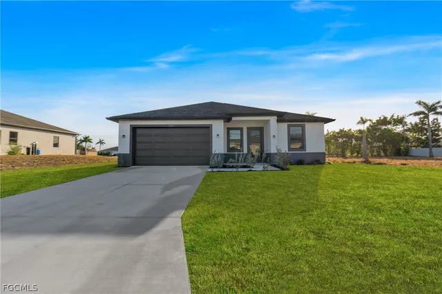a front view of a house with a yard and garage