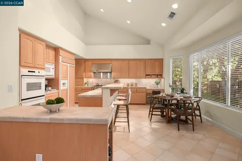 a kitchen with stainless steel appliances kitchen island granite countertop a sink and cabinets