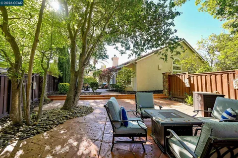 a backyard of a house with table and chairs
