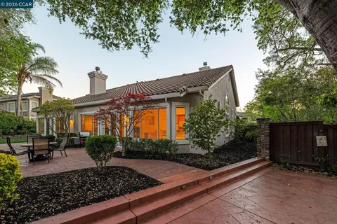 a front view of house with yard space and trees around