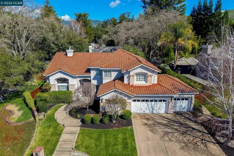 a aerial view of a house next to a yard
