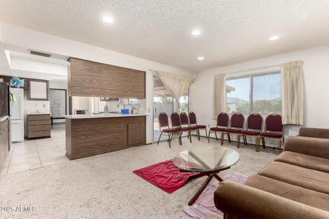 a living room with furniture a rug and a table