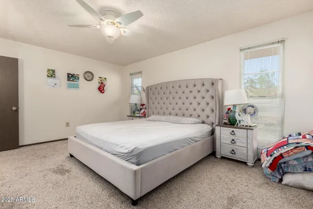 a bedroom with a bed and a baby bed