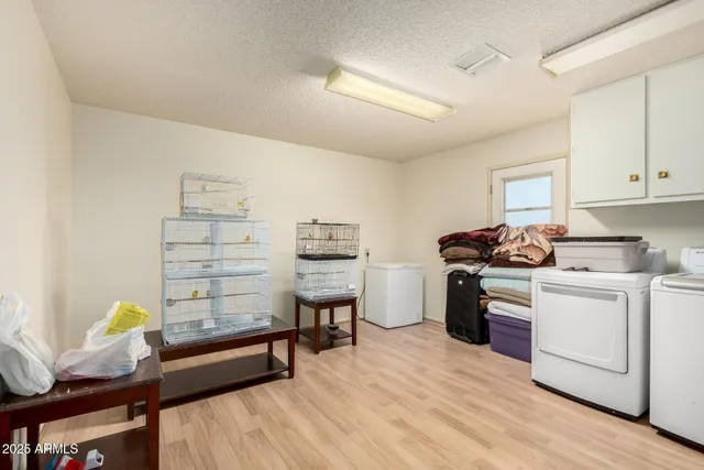 a kitchen with a sink cabinets and wooden floor