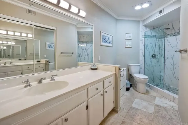 a spacious bathroom with a double vanity sink toilet and a shower