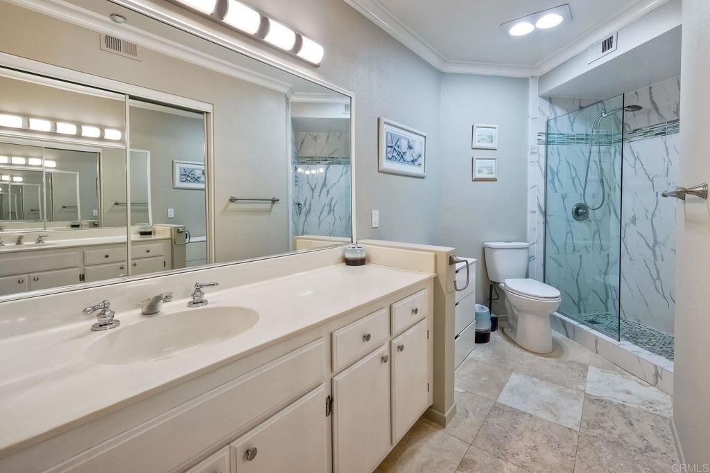 400 The Strand North, Unit 18 Oceanside, CA 92054 - Photo 9 of 19 a spacious bathroom with a double vanity sink toilet and a shower