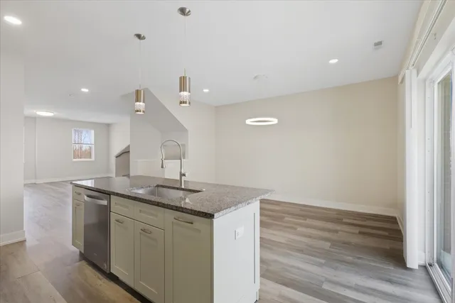a hallway with sink and mirror