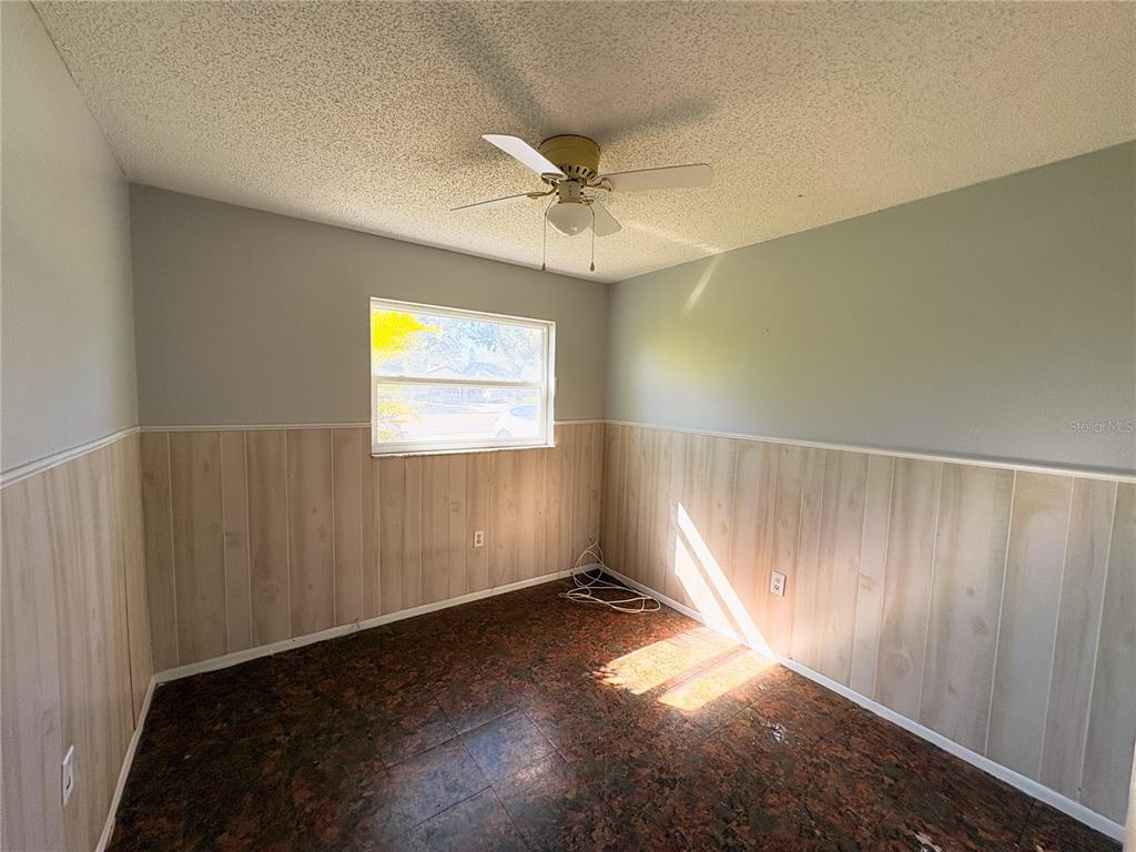 11333 Walsingham Road Largo, FL 33778 - Photo 12 of 34 an empty room with windows and fan view