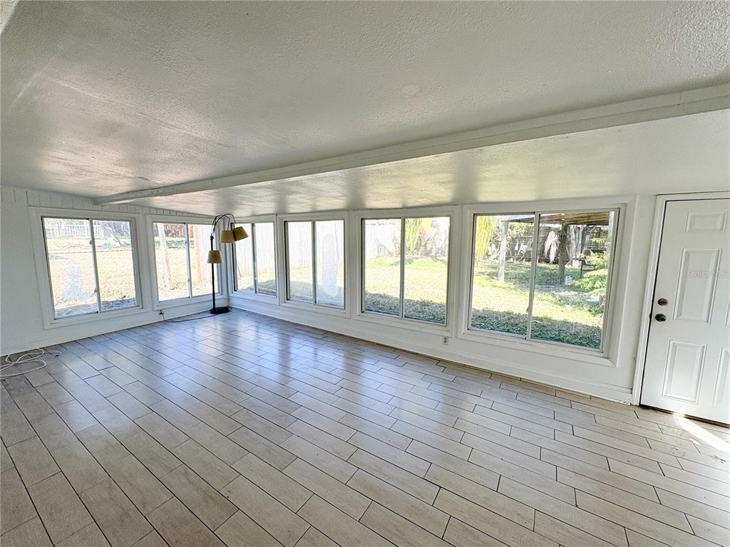 11333 Walsingham Road Largo, FL 33778 - Photo 25 of 34 wooden floor in an empty room with a window