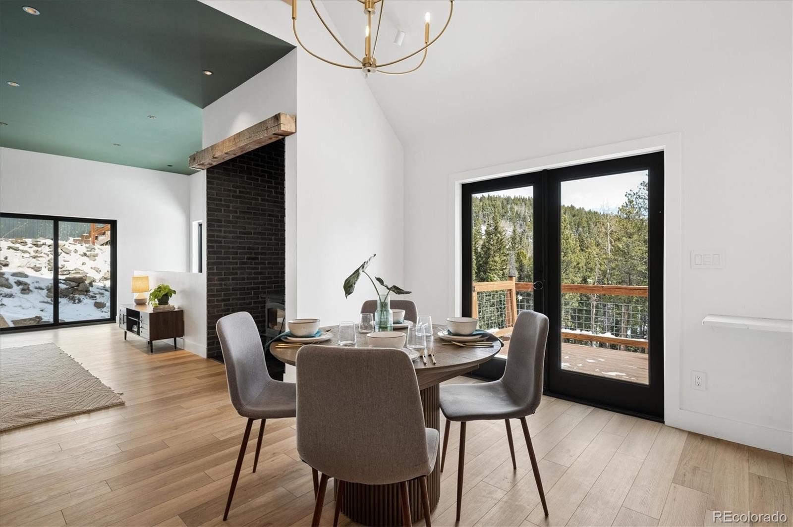 1633 Sinton Road Evergreen, CO 80439 - Photo 30 of 50 a dining room with furniture and wooden floor