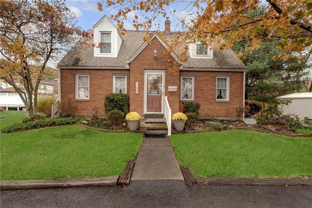 a front view of a house with a garden and plants