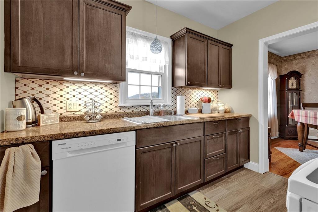 1400 Market Street Beaver, PA 15009 - Photo 2 of 23 a kitchen with granite countertop stainless steel appliances a sink window and cabinets