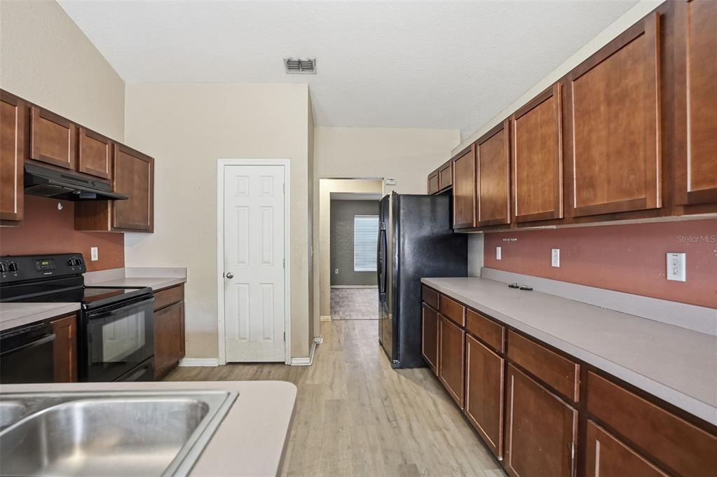 10490 Mayflower Road Spring Hill, FL 34608 - Photo 11 of 35 a kitchen with stainless steel appliances granite countertop a refrigerator a sink dishwasher a stove and a microwave oven on granite countertops