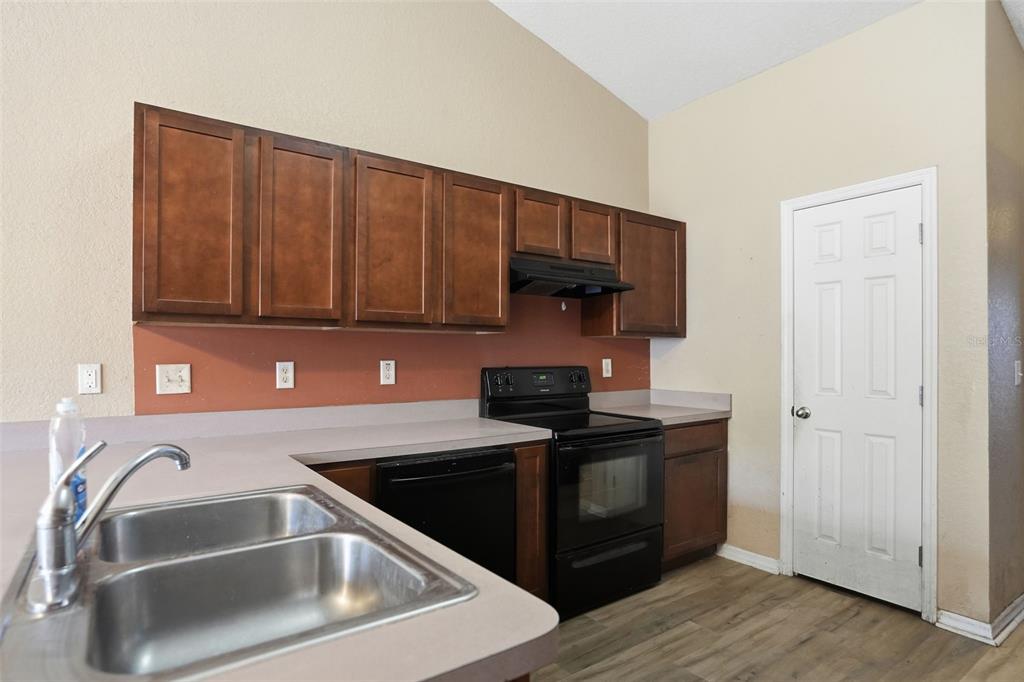 10490 Mayflower Road Spring Hill, FL 34608 - Photo 12 of 35 a kitchen with a sink stove and cabinets