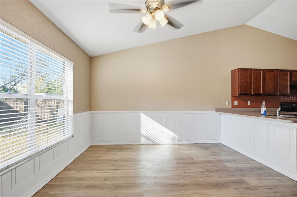 10490 Mayflower Road Spring Hill, FL 34608 - Photo 13 of 35 a view of a kitchen with wooden cabinet and a hallway