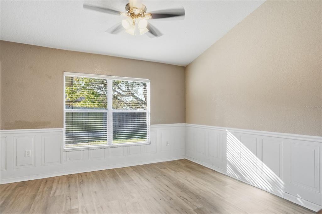10490 Mayflower Road Spring Hill, FL 34608 - Photo 14 of 35 a view of an empty room with a window and wooden floor