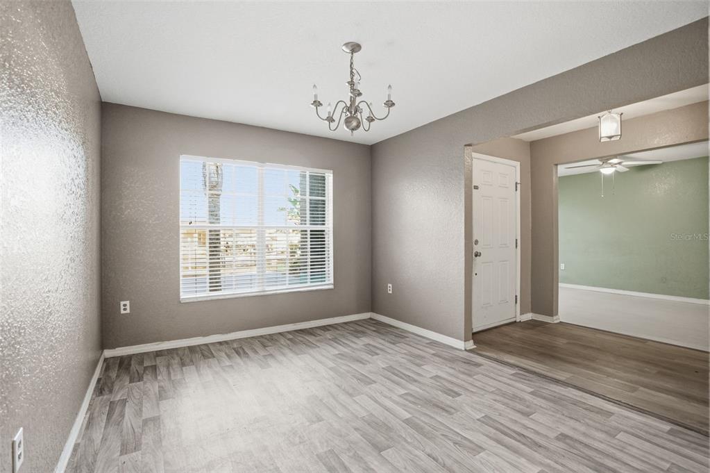 10490 Mayflower Road Spring Hill, FL 34608 - Photo 15 of 35 a view of an empty room with window and wooden floor