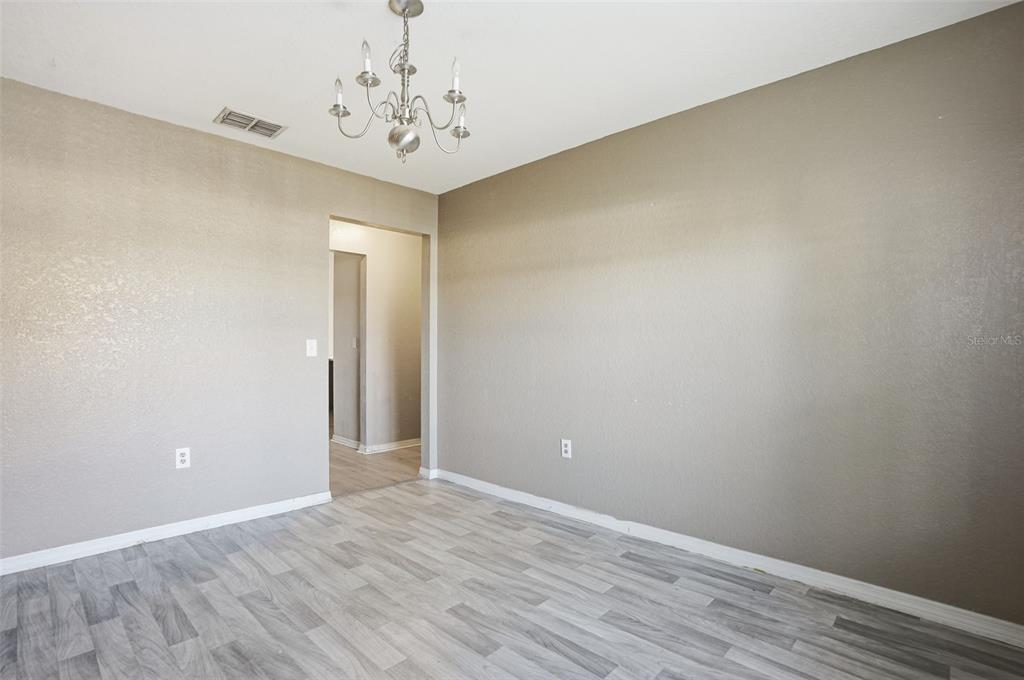 10490 Mayflower Road Spring Hill, FL 34608 - Photo 16 of 35 a view of an empty room with wooden floor