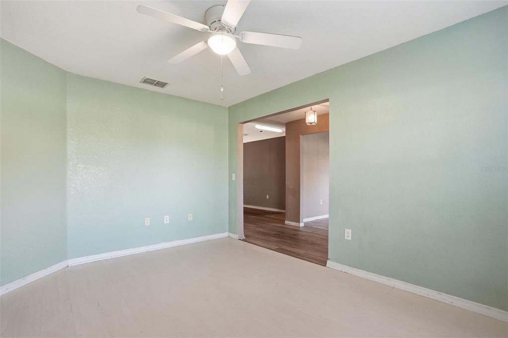 10490 Mayflower Road Spring Hill, FL 34608 - Photo 18 of 35 an empty room with closet and a chandelier fan