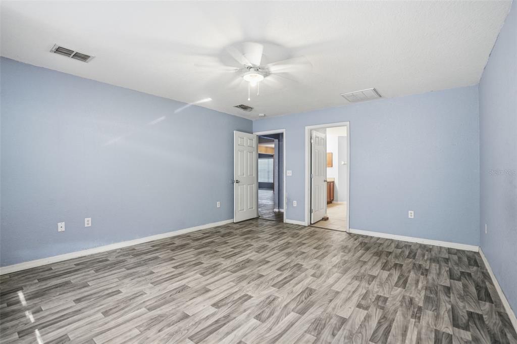 10490 Mayflower Road Spring Hill, FL 34608 - Photo 20 of 35 wooden floor in an empty room with a window