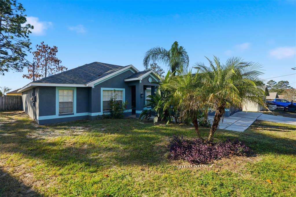 10490 Mayflower Road Spring Hill, FL 34608 - Photo 2 of 35 a view of a house with a yard and sitting area